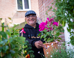 Bewoner poseert met bloempot in handen